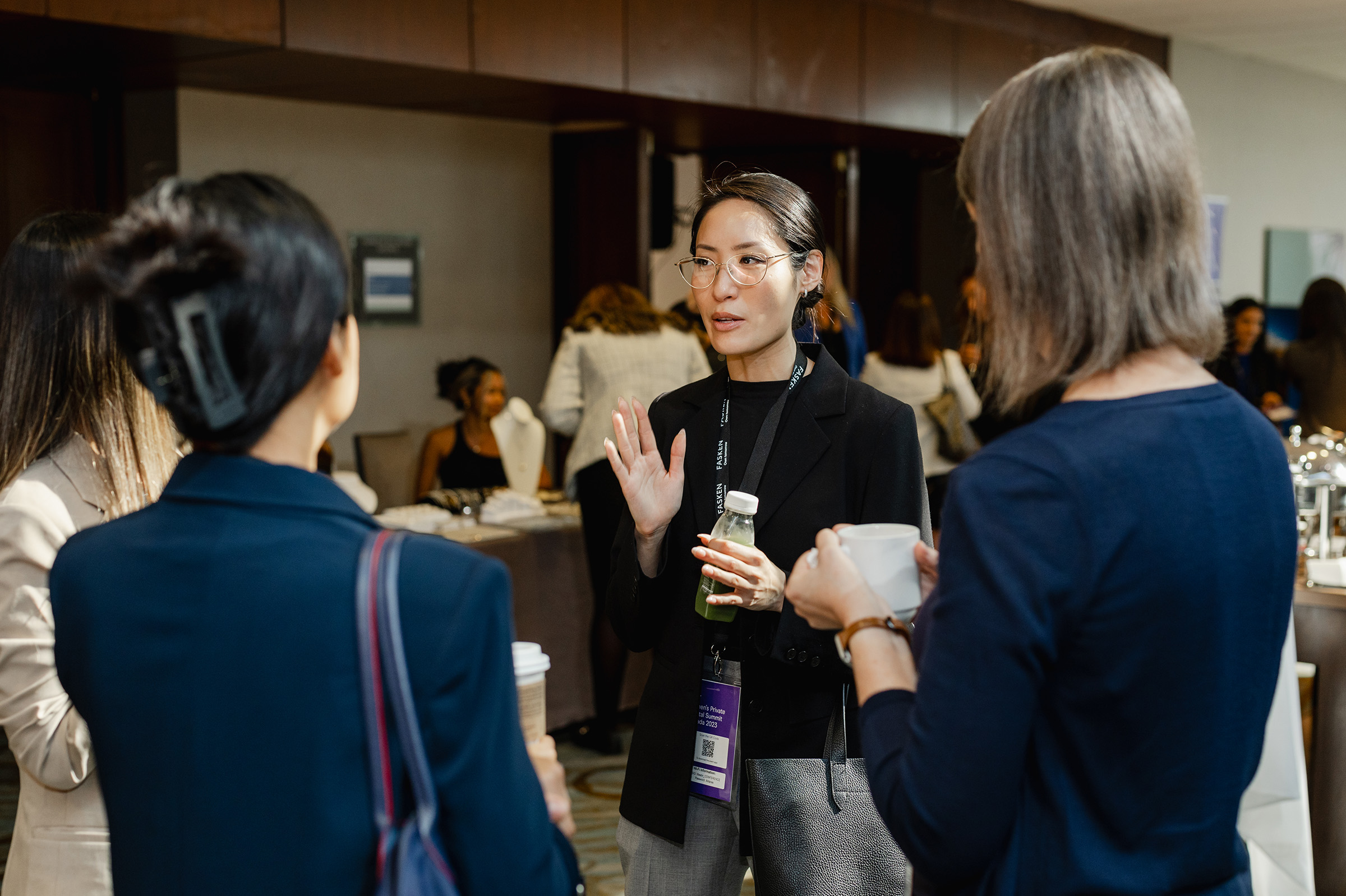 A group of women engaging in content creation at a business event.