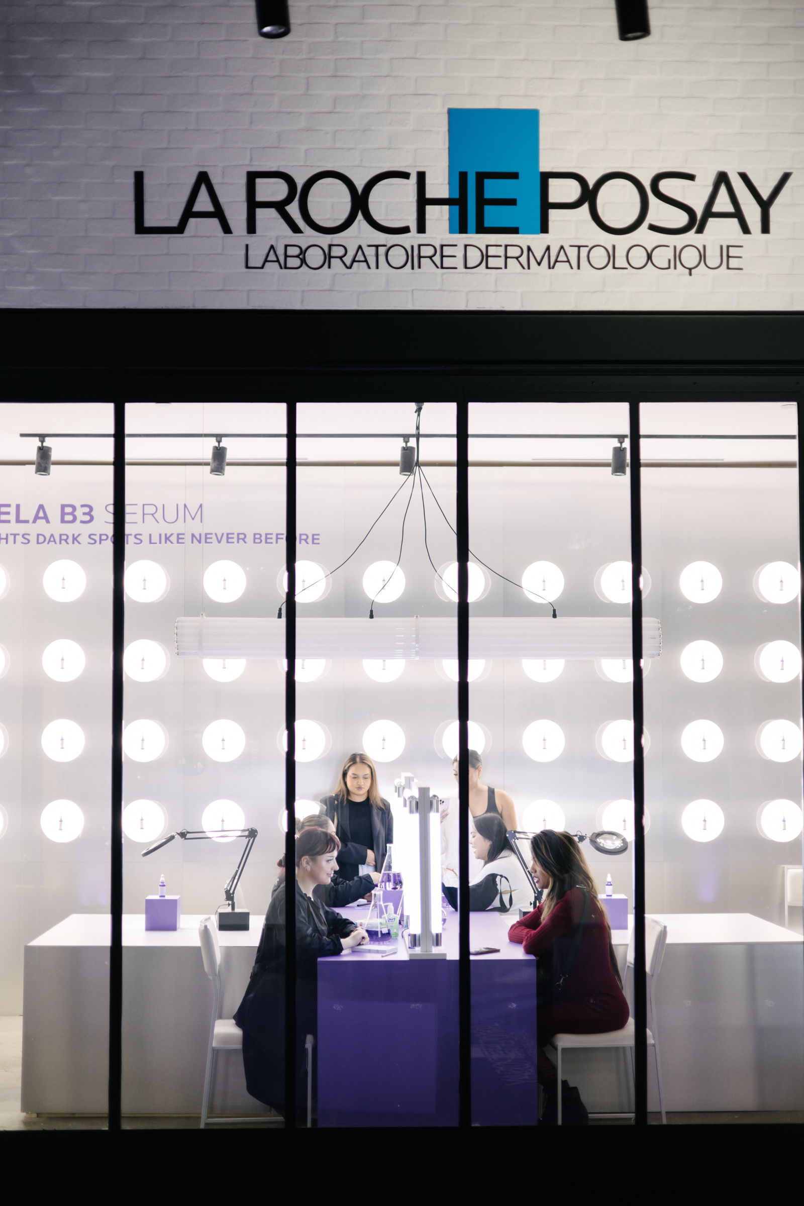 Corporate photography captures the essence of the La Roche-Posay dermatology lab storefront, showcasing individuals exploring innovative skincare solutions inside.